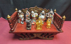 A small Thai wooden elephant seat, with 5 Chinese porcelain figures, 2 gold Chinese figures and a jade figurine