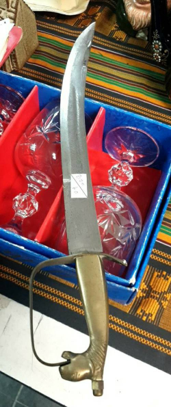 Short  Saber sword with engraved decoration and lion mask handle. L.39 Cm,