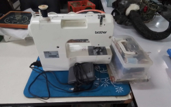 A Brother Electric Sewing Machine with Cottonand Accessories.