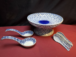 A Large open bowl with 8 soup spoons blue & white