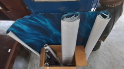 2 Rolls of Blue Wall Paper and mixed items in the box.